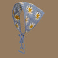 Blue crochet pet bonnet with yellow and white floral pattern and tie strings