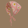 Pink knit pet bonnet with white daisy flower pattern and tie strings