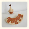 Ice cream cone pet hat and donut-shaped pet accessory with sprinkles on a light background