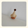 Brown and beige pet birthday hat with pompom on top, soft textured fabric on neutral background